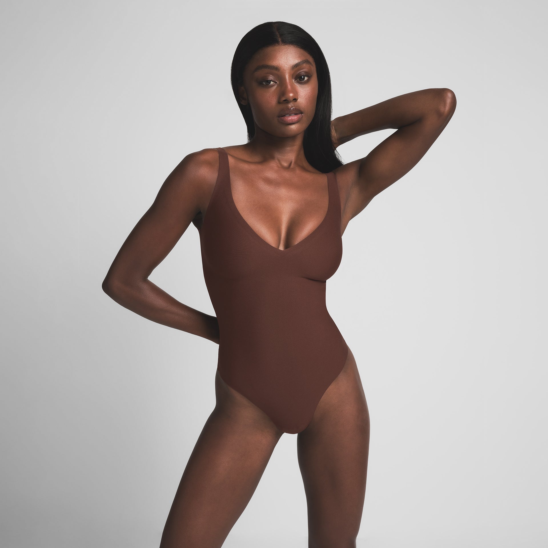 SKIMS BODY UNLINED PLUNGE THONG BODYSUIT | COCOA